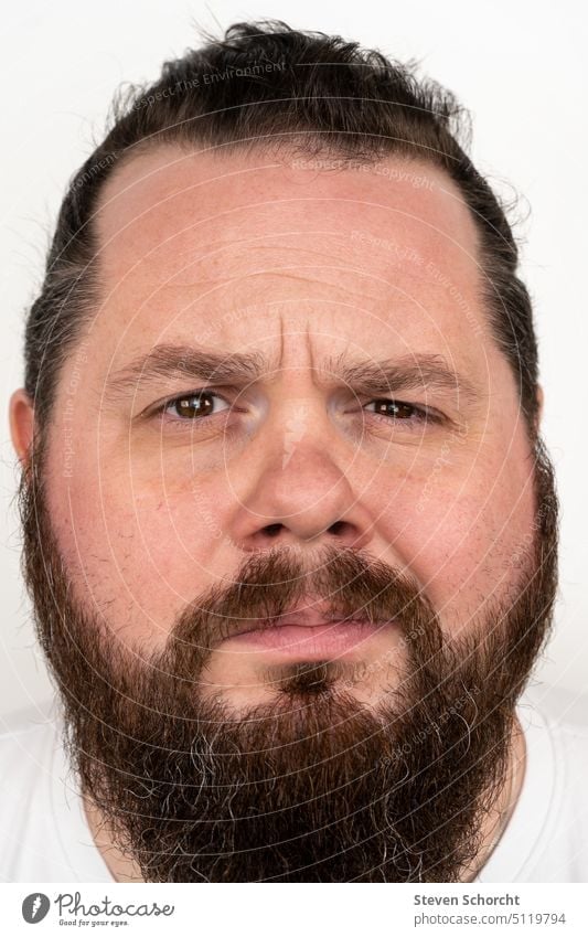 Man with beard looks skeptically at camera portrait Human being Face of a man Head Looking into the camera Facial hair Colour photo Masculine Forward Adults
