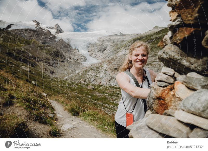 Portrait of a young woman in front of a glacier in the Alps Young woman Hiking Mountain Hohe Tauern National Park Colour photo Hohen Tauern NP Austria Nature