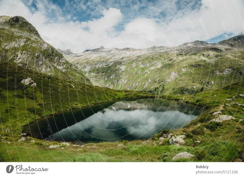 Small lake in the middle of the mountains of the Alps Mountain Peak Landscape mountain lake Lake reflection Austria Hohe Tauern National Park Hiking hike
