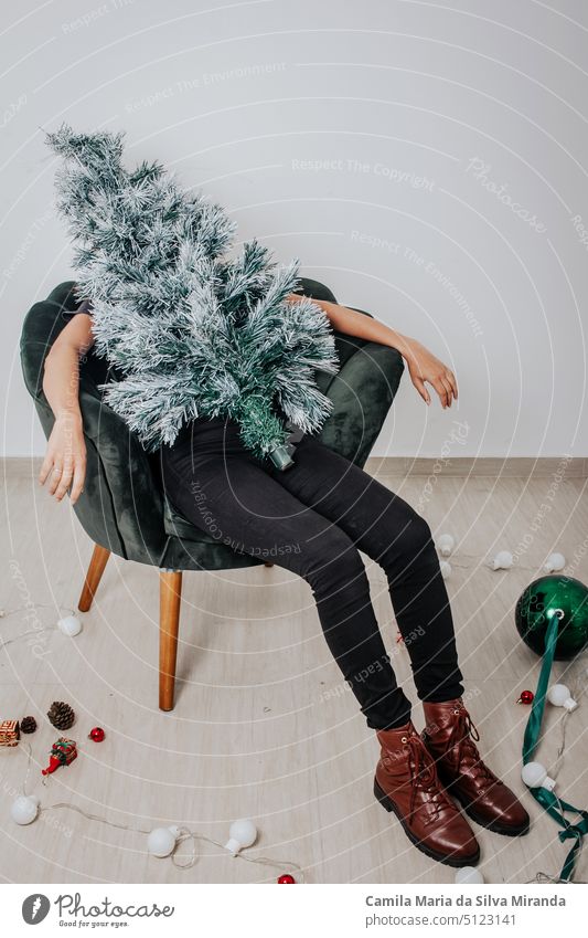 Woman dressed as a Christmas tree. End of party, tree dismantled. Christmas tree. celebration christmas christmas tree decoration emotions fashion fun girl