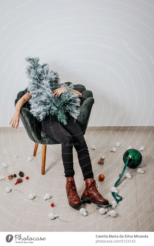 Woman dressed as a Christmas tree. End of party, tree dismantled. Christmas tree. celebration christmas christmas tree decoration emotions fashion fun girl