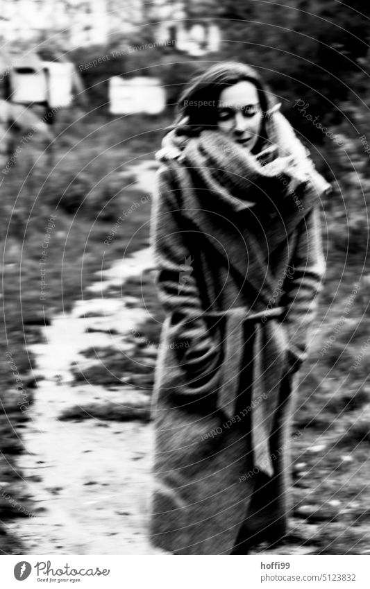 the woman walks pensively, looking down towards the camera portrait ICM motion blur hazy Abstract vibrating Mysterious Ambiguous blurred somber Strong strength