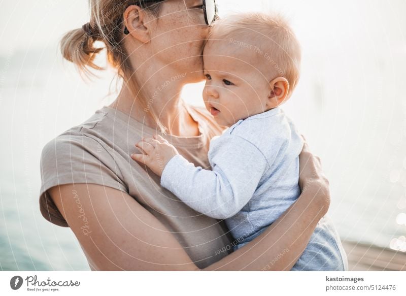 Beautiful Mother And Baby outdoors. Mum and her Child together enjoying sunset woman mother beautiful little fun mom child parent family care love childhood kid