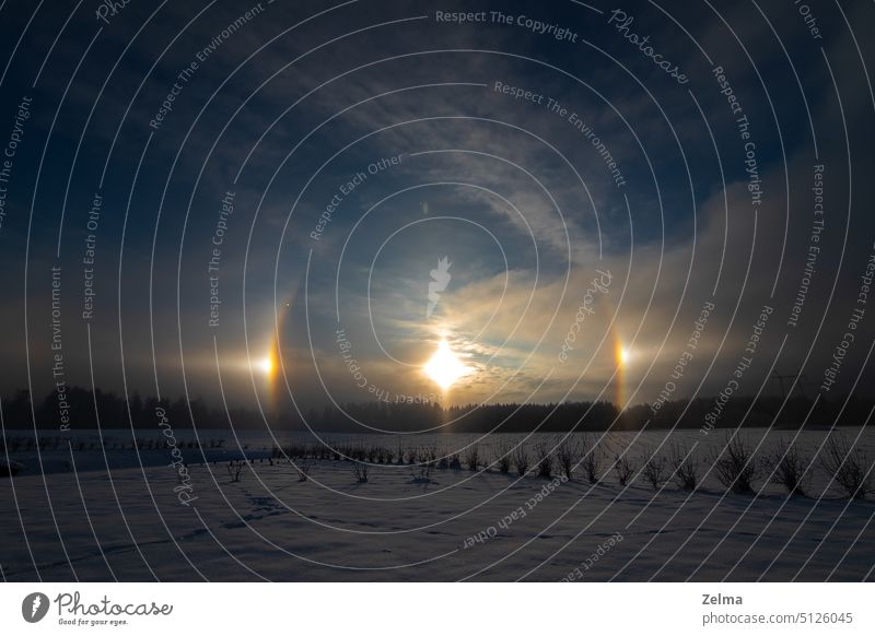 Sunset in the winter and natural atmospheric phenomenon Halo, parhelion, parhelia, sundog in Latvia halo rainbow nature mock sun ice crystals atmosphere sunset