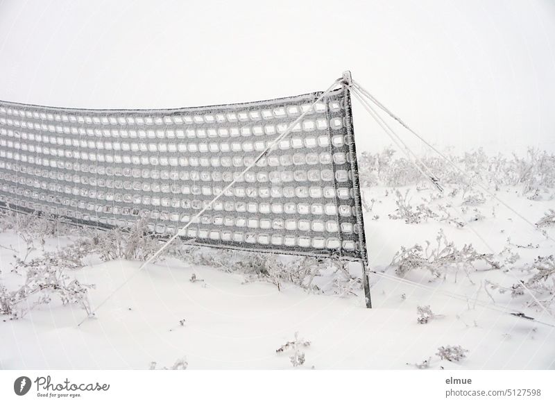 stretched end of snow fence in snowy landscape / winter Snow guard net Snow fence Winter Frost Landscape Safety Virgin snow Net Blog meshes demarcation