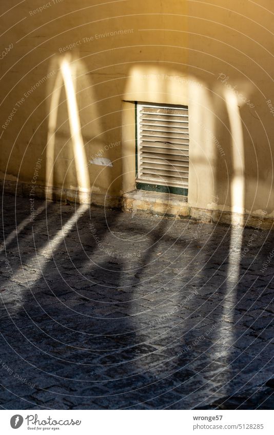 Cross Appearance reflections Flare light spots Town Footpath house wall Facade Exterior shot Deserted Building Colour photo Window Cellar window Day