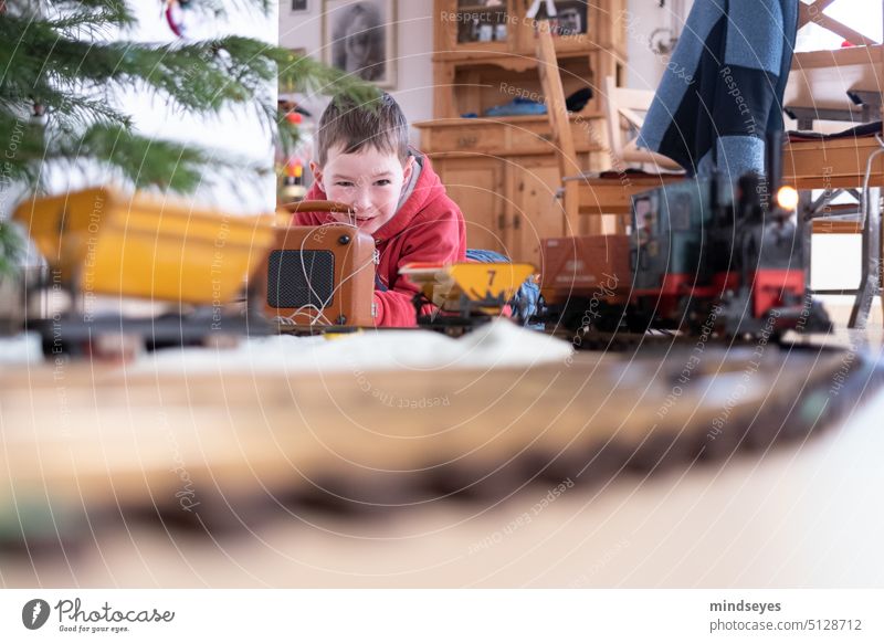 Playing with the model railroad Christmas at home Model railroad Train under the christmas tree electric railroad Toys Festive Joy Infancy Child Childhood dream