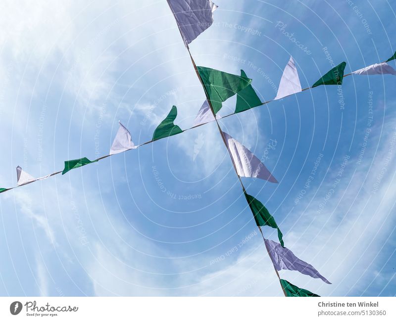 two green-white pennant strings fluttering in the wind, above the slightly cloudy sky pennant chain Pennant Chains Feasts & Celebrations Decoration Summerfest
