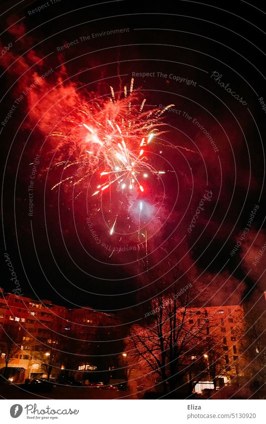 Red fireworks on New Year's Eve Firecracker turn of the year Night Feasts & Celebrations Residential area Party new year's eve fireworks Sky Explosion Night sky