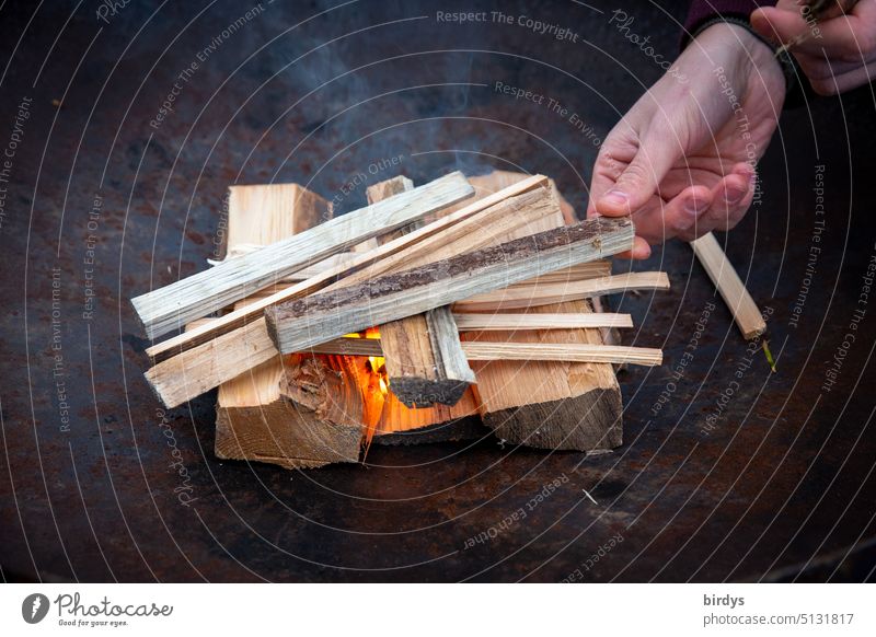 Start a wood fire in a fire bowl Fireplace ignite kindling firewood Flame Hand Wood Wood fire Smoke