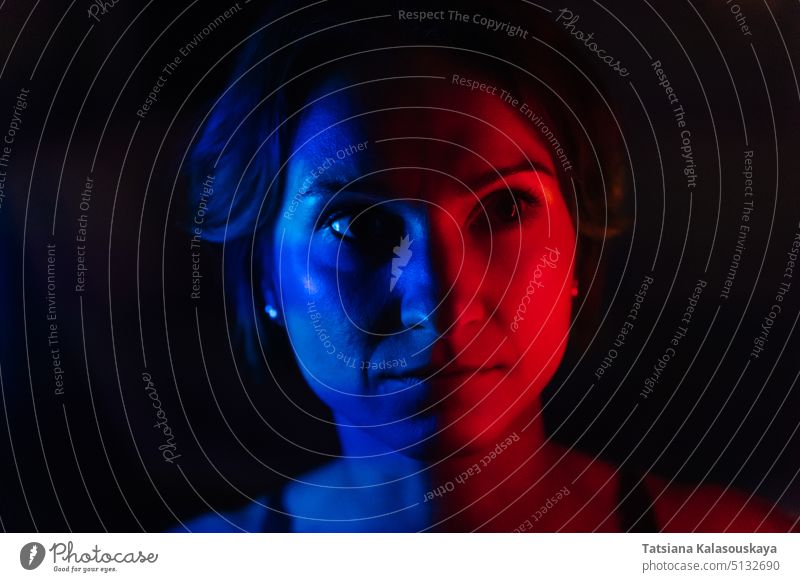 The face of a young woman in blue and red neon light on a dark background Portrait Neon Lighting Neon Colored Illuminated Colors Magenta Color Image People
