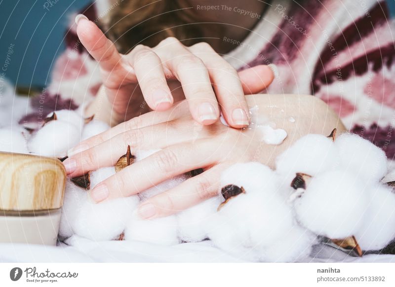 Close up of a young woman applying cream in her hands cosmetics lotion organic eco bio delicate respectful care skin product application fragile manicure