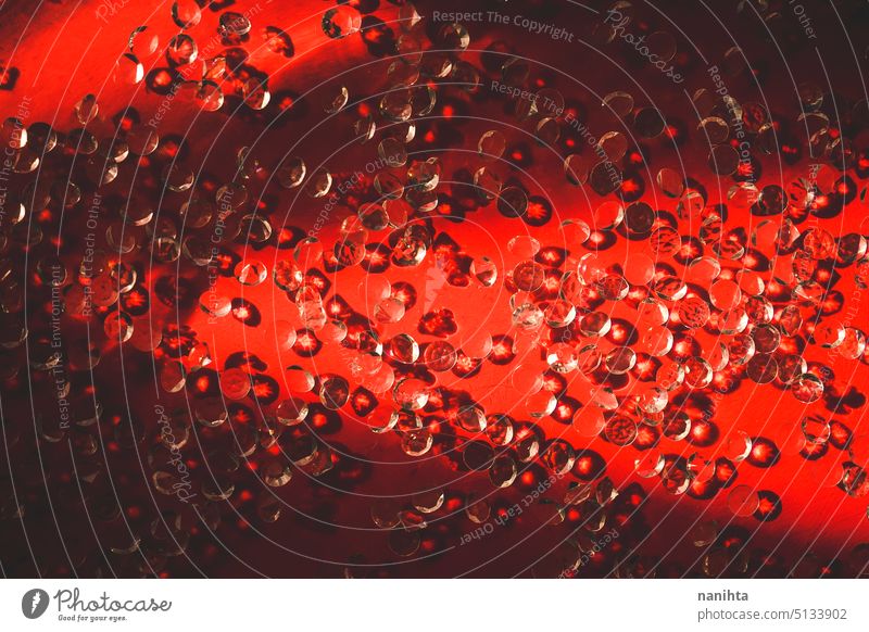 Red background with a lot of little diamonds in a water surface red elegant jewlery wealth pattern abstract clean new luxury shine light sunlight shadow