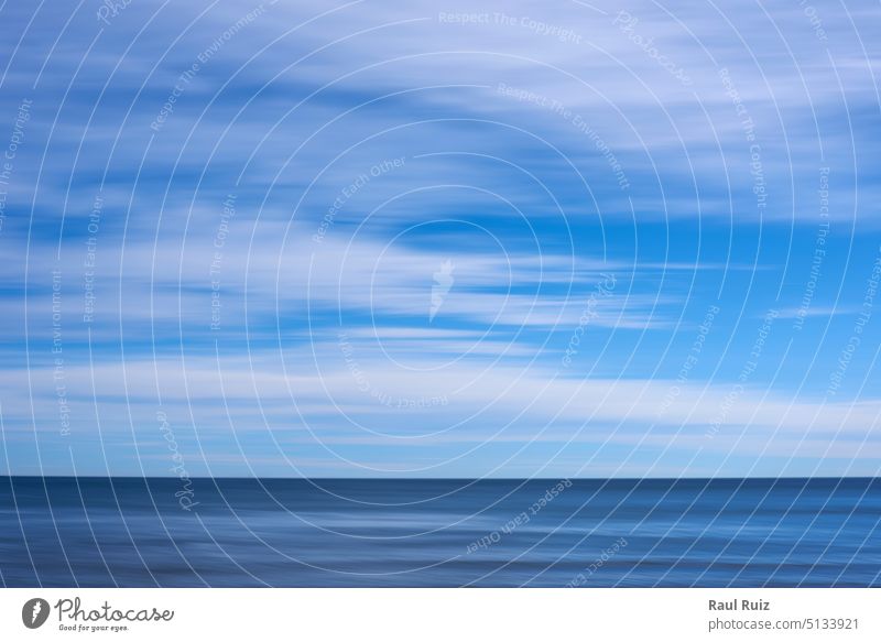 Blue colour background, beach with clouds and sky fog smooth motion seascape abstract defocused empty blue sunset coastline artistic blur cloudscape creativity