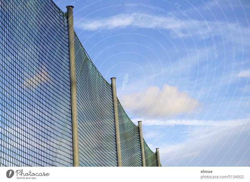 Ball catching net in sunshine against blue sky with fair weather clouds and chemtrails ball net Net Sporting grounds Ball sports Ball game Ball game net meshes