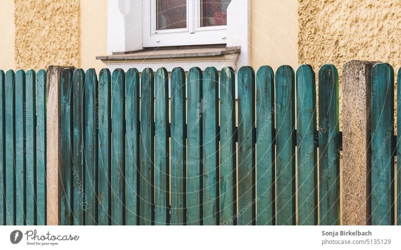 A green fence in all the gray (yellow) Fence Fencing Garden fence lattice fence Green House (Residential Structure) Real estate Old Exterior shot Border
