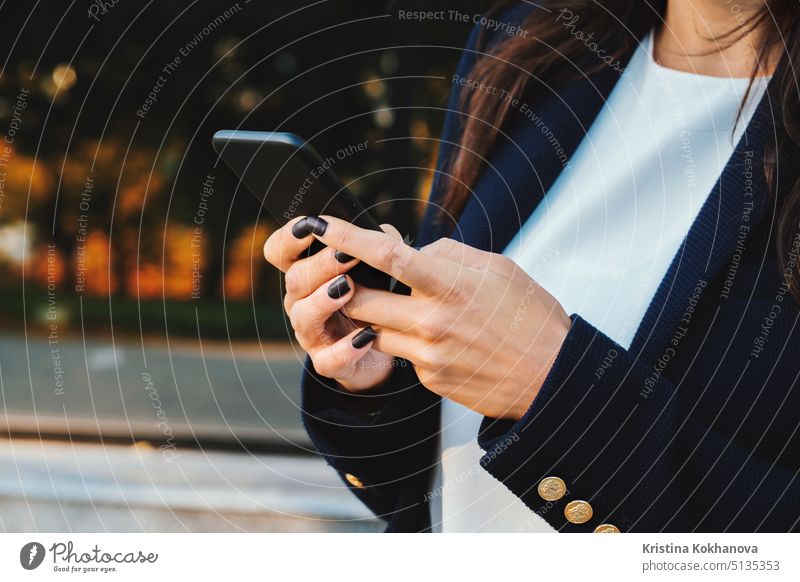 Businesswoman with smartphone. Student girl using cell phone. Beautiful woman in glasses surfing internet on mobile device. Female with modern technolody device.
