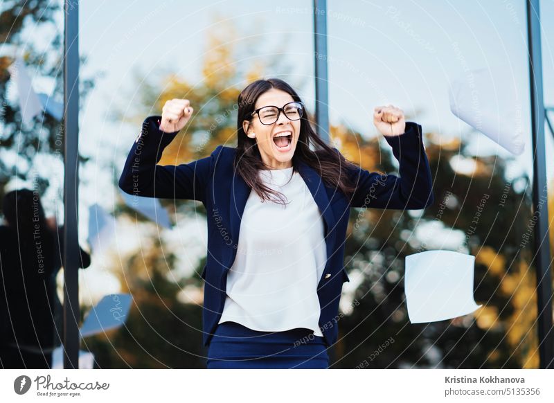Angry furious female businesswoman screaming in anger. Stress management, mental distress problems, losing temper, reaction on failure. throwing crumpled paper, having nervous breakdown at work