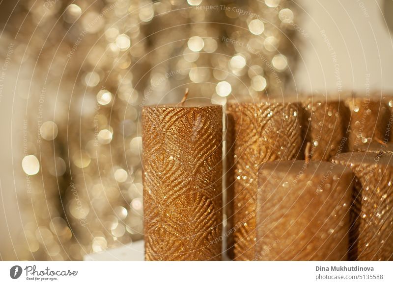 Golden brown color candles on the shelf of Christmas store with bokeh background closeup with copy space wax golden christmas business holiday marketing
