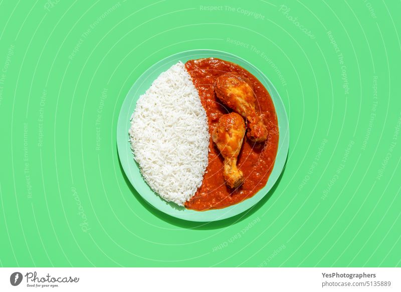 Rice and chicken stew dish, above view on a green background african bright chili color cooked cuisine curry cut out delicious dinner food fried gourmet