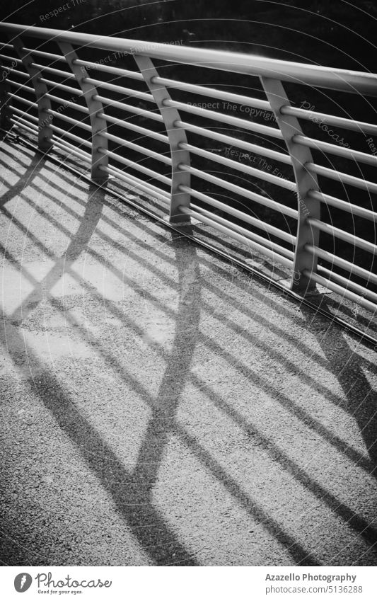 Black and white image of bridge handrails with hard shadow. abstract architectural architecture art backdrop background black black and white black shadow