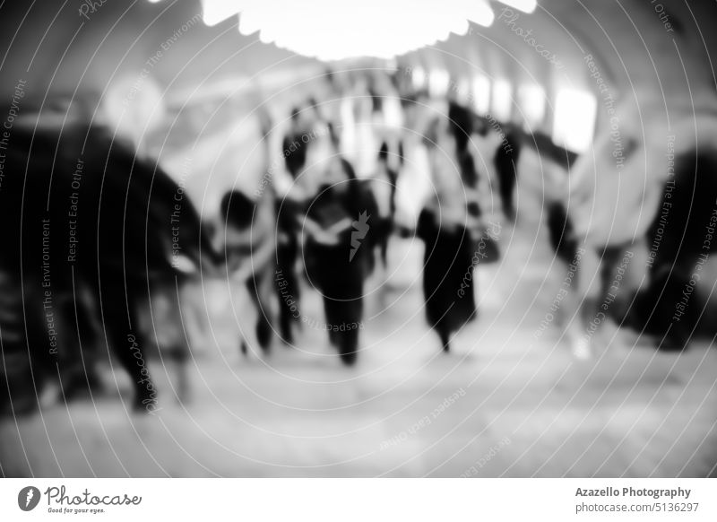 Lens blur image of a subway with silhouettes of moving people. blurry human concept minimalism abstract art backdrop background blurred bokeh bright carriage