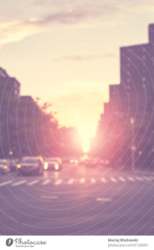 Blurred picture of a street at sunset, urban abstract background, color toning applied, New York City, USA. city blur retro road light asphalt evening bokeh