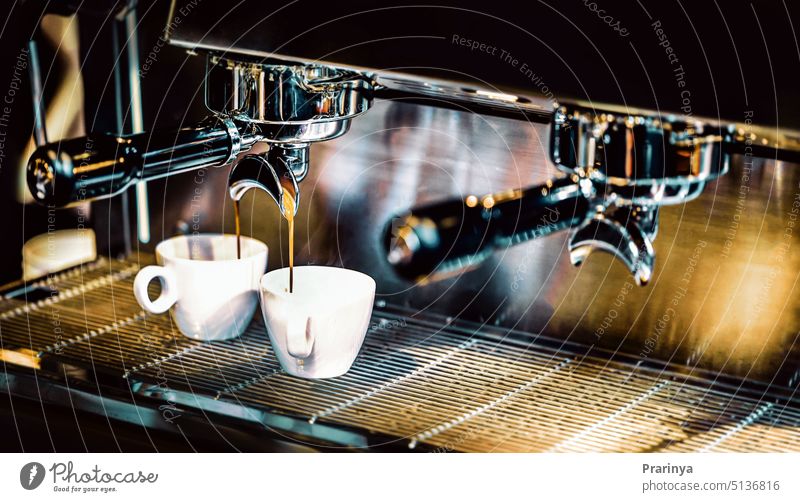 Espresso machine brewing a coffee. Coffee pouring into glasses in coffee shop, espresso pouring from coffee machine barista cafe fresh hot drink beverage