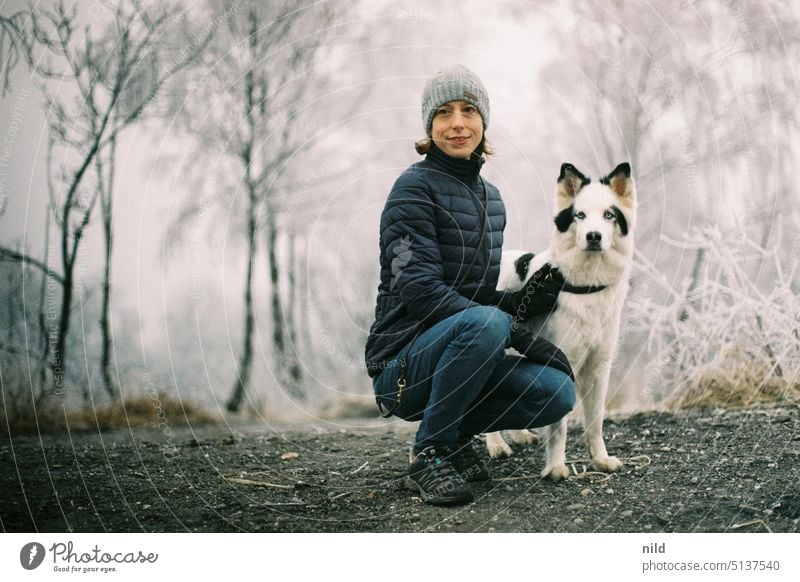 Young woman with her dog in winter landscape chill Hoar frost Dog Team in common Friendship at the same time Man and dog Humans and animals Winter