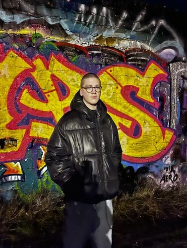Youth in front of graffiti wall in the dark Graffiti younger Young man darkness Man Human being Exterior shot 16 years 18 - 30 years Masculine