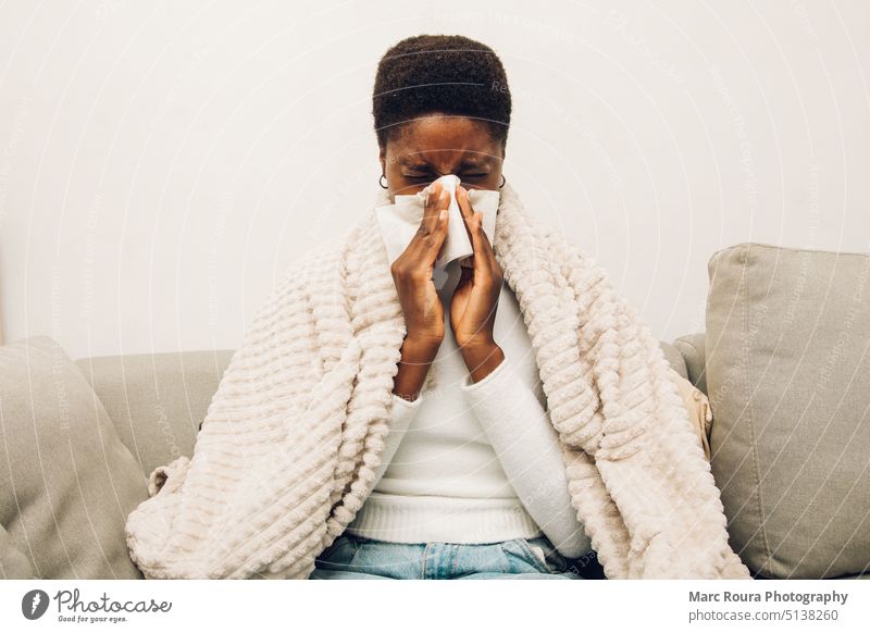 a black woman blowing their nose air pollution asia asian bed bedroom blanket care caucasian cold couch covid-19 disease fever flu girl hay fever headache