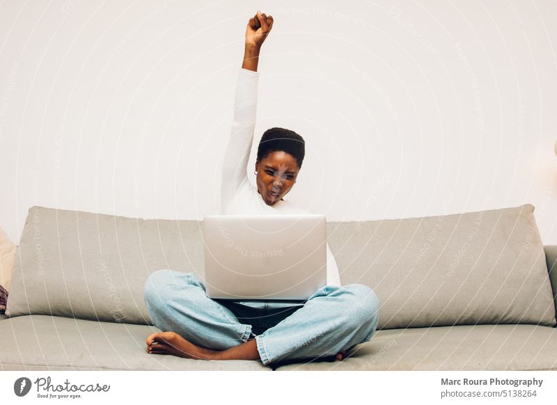 person with laptop gesturing celebration achieve result african afro american background beautiful black casual celebrating cheerful customer smile entrepreneur