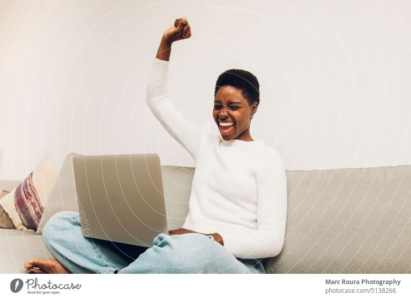person with laptop gesturing celebration achieve result african afro american background beautiful black casual celebrating cheerful customer smile entrepreneur