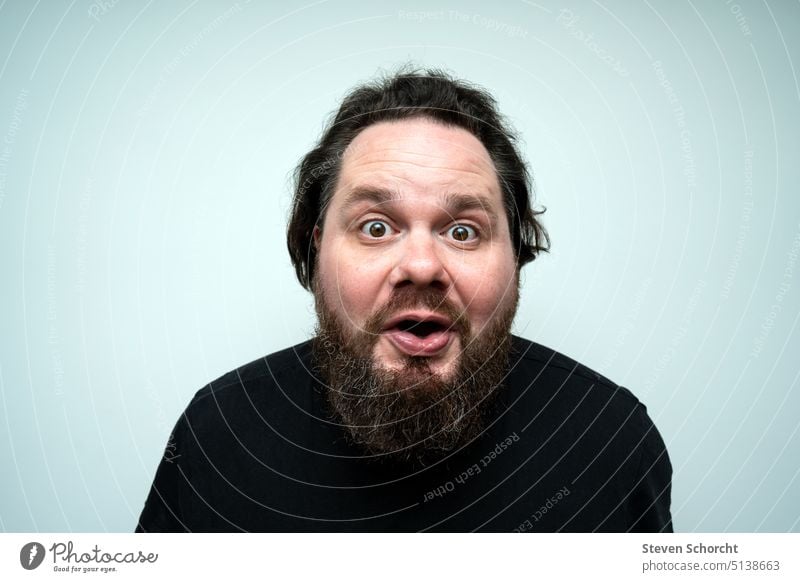 Man with beard looks at camera in surprise Facial hair Face portrait Human being Looking Adults Curl Colour photo Young man Head Hair and hairstyles