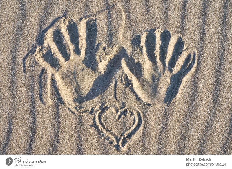 Hand print with heart in the sand on the beach. Wavy sand. Still life on the seashore hand print finger imprint travel vacation water perspective baltic sea