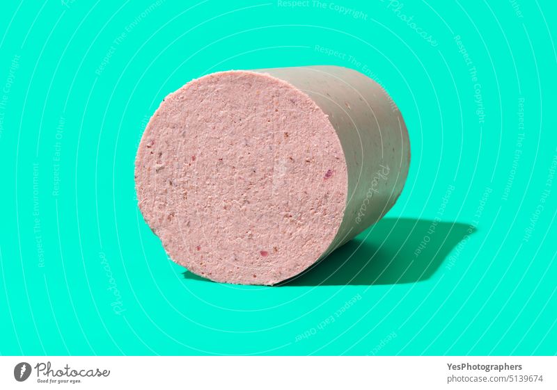 Homemade baloney isolated on a green background. appetizer boiled bologna breakfast bright chicken chunk close-up cold color copy space cuisine delicious dinner