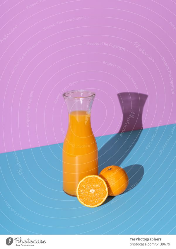 Orange juice bottle isolated on a vibrant background. beverage blue break breakfast bright carafe citrus cold color colors copy space delicious dessert diet