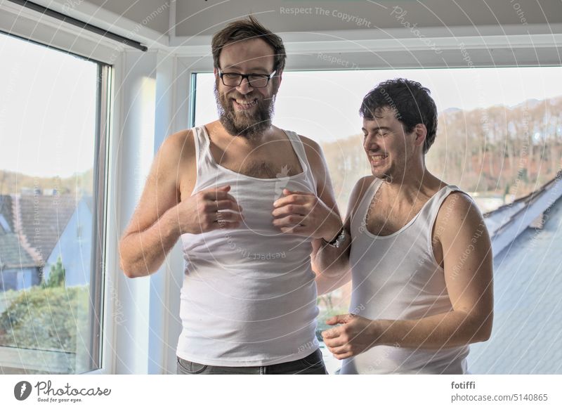 two young men in undershirts, laughing Undershirt Laughter Friends Friendship Joy Together Happy Positive fun Fine rib Cheerful youthful Male adults pretty