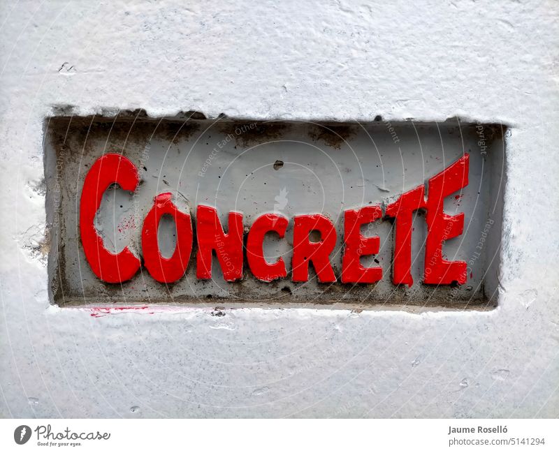 concrete word embossed on a concrete surface red painted letters. floor grey grunge material rough textured dirty abstract stained structure gray exterior slab