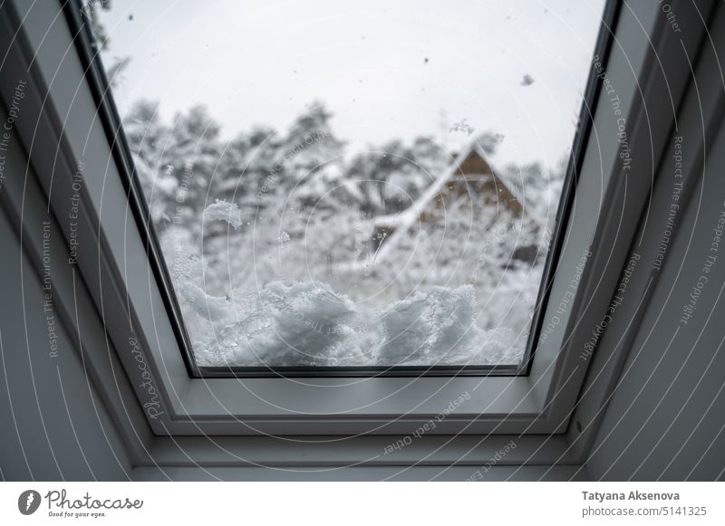 Window on roof covered by snow window winter cold house view europe estonia insulation ice cooling double glazing glass unit home improvement