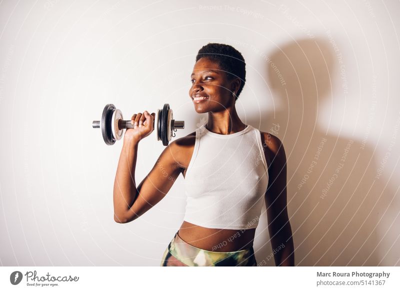 black woman with a dumbbell active activity adult arm athlete beautiful biceps biceps curl city copy exercise female fit fitness fresh girl happy health healthy
