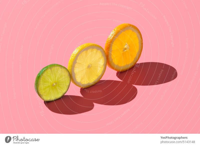 Citrus fruits variety, single slices isolated on a pink background. abstract aligned bright citrus color colorful concept copy space creative cuisine cut out