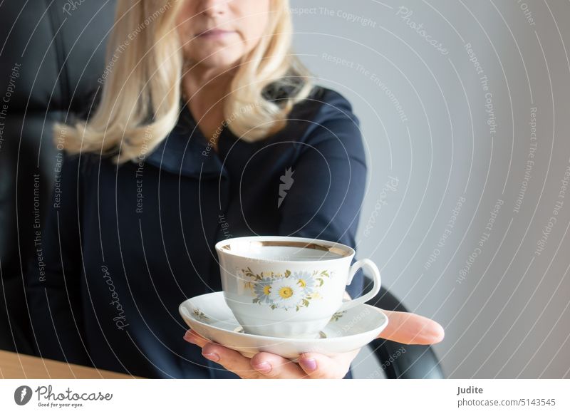 Woman holding a cup of coffee with a saucer. Selective focus on the cup adult attractive beautiful beauty beverage blonde cafe caffeine casual caucasian company