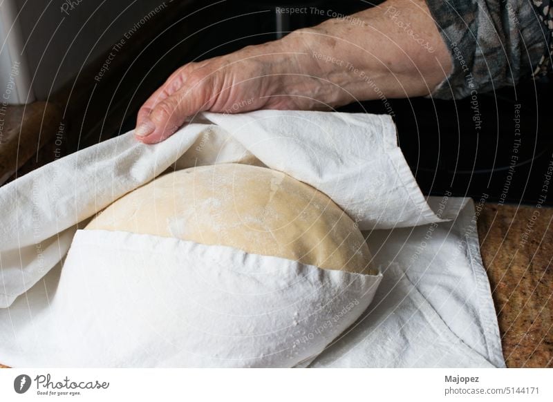 Unrecognizable human hanad checking the casadielles dough during rising raw pastry aged woman background bakery bread brown caucasian close up copy space