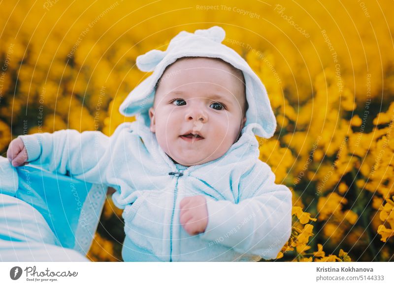 Cute little baby boy portrait in canola rapeseed field on yellow flowers background, family, son, toddler child concept. beauty day beautiful fun cheerful