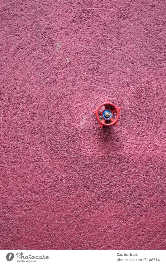 Red wheel of a valve for water on wall with rough plaster in old pink as background or accent Wheel Valve Wall (building) Plaster harsh coarsely dusky pink