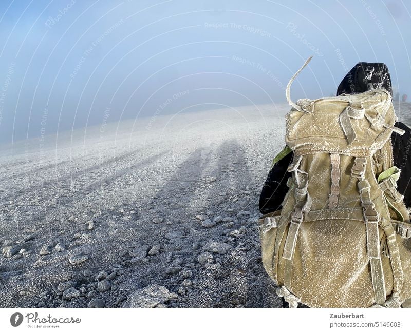 Hoop covered backpack, shadow in morning light, scree, sky on Kilimanjaro crater rim Backpack Mature Snow Ice Gravel Shadow Morning height Sun Sunrise