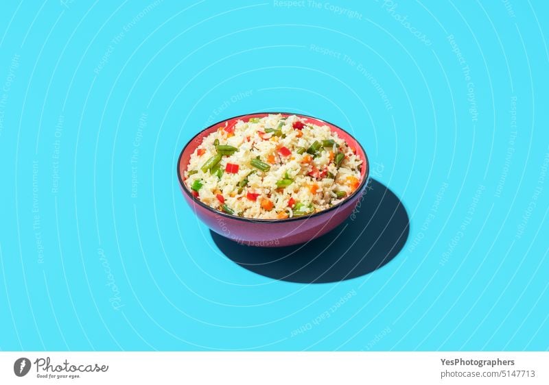 Fried rice dish isolated on a blue background above asian beans bowl bright carrot chinese color cooking copy space cuisine cut out delicious diet dinner food