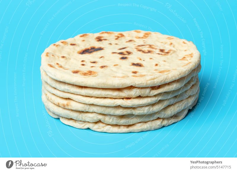 Naan bread isolated on blue background. Stack of indian flatbread. afghan aligned arabic arranged asian baked bakery balkan classic color cuisine delicious