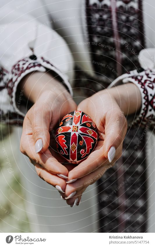 Ukrainian woman holding in hands Easter egg. Beautiful geometric slavic decoration. Lady in embroidery vyshyvanka dress. eggs food natural tradition traditional